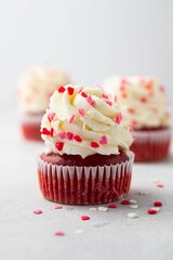 Red velvet cupcake with cream cheese frosting and red hearts sprinkles on the top. Valentine's Day...