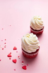 Red velvet cupcakes with cream cheese frosting on pink background. Valentine's Day concept. Top view, copy space. Selective focus.