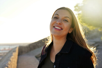 Young brazilian woman smiling at sunset