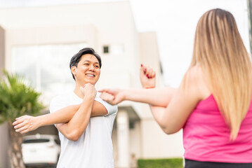 close-up horizontal shot of couple warming up outdoors 