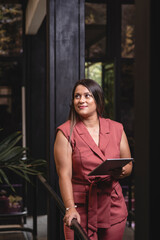 Beautiful Latina businesswoman with a digital tablet in her hands 