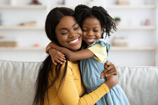 Mother Daughter Love. Happy Black Woman Hugging With Her Child At Home