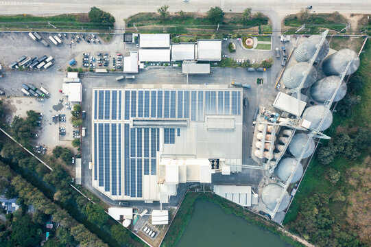 Eco building or factory in aerial view consist of solar or photovoltaic cell in panel on top of roof. Technology to generate electrical power, direct current electricity by light. Energy for future.