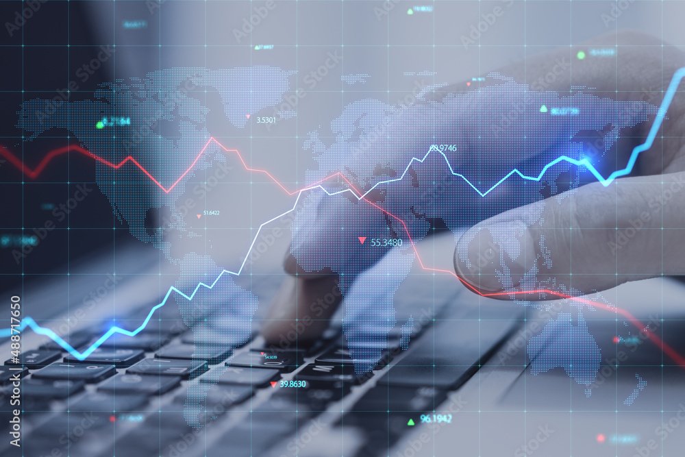 Poster close up of businessman hands using laptop keyboard with creative glowing blue map hologram with cha