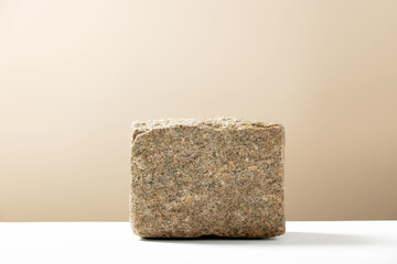 Stone podium for showing packaging and product on natural beige background, copy space