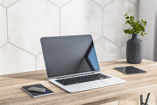 Close up of modern laptop near smartphone and digital tablet on wooden table surface in stylish home work place. 3D rendering