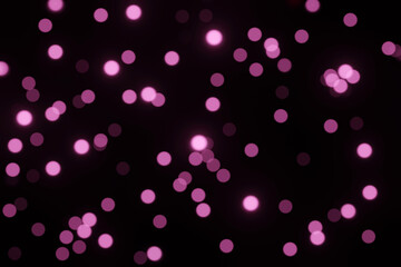 Defocused bokeh lights on black background, an abstract naturally blurred backdrop for Valentines Day or birthday party. Festive light texture. Violet blue garland in blur. Color 2022
