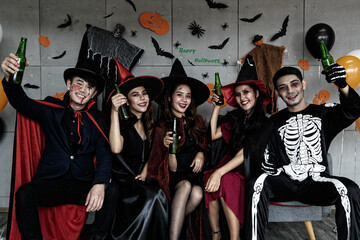 Portrait shot group of Asian young happy male and female friends in Halloween witch sorcerer ghost...