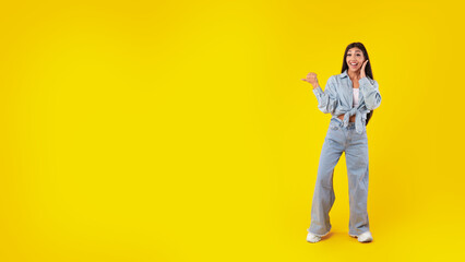 Excited woman pointing aside at copy space