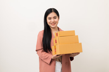 Young beautiful asian woman with many parcel cardboard standing on isolated white background. Delivery woman holding lot of parcel box sending to messenger.