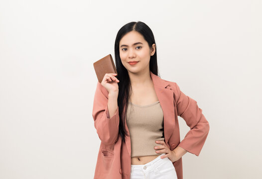 Young beautiful asian woman with brown wallet on isolated white background. Financial and investment concept. Business asian woman in suit counting money in wallet.