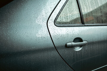 Water droplets on car windshield. Heavy rain fell on the roof of the car. Driving on rainy days, be...