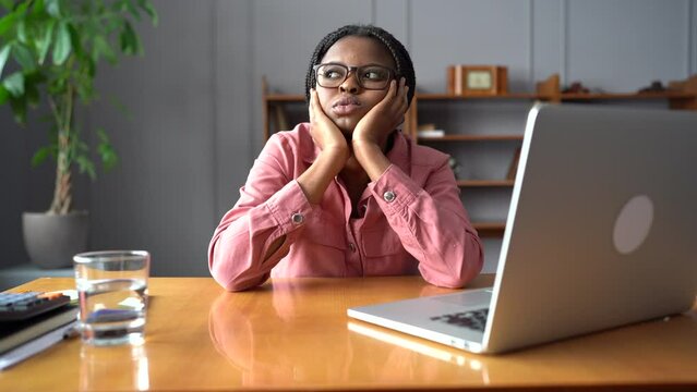 Overworked african businesswoman suffer from burnout and migraine at workplace tired looking for solution to business problem feel depressed unhappy. Frustrated freelancer female sick from headache