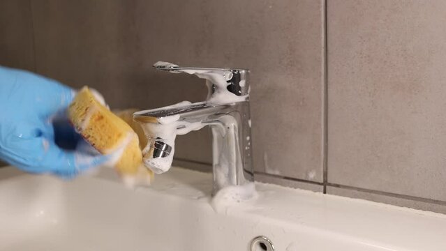 the cleaning company cleans the bathroom with the help of professional products for removing dirt and plaque from plumbing