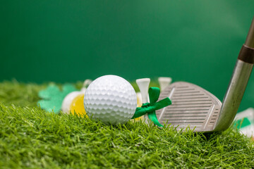 Golf ball for St. Patrick's Day on green grass. St. Patrick's Day is celebrated annually on March...