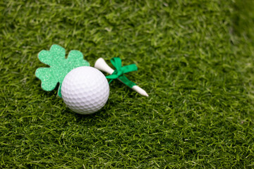 Golf ball for St. Patrick's Day on green grass. St. Patrick's Day is celebrated annually on March...