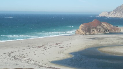 Little sur river beach on Pacific Coast Highway 1, scenic Cabrillo road. Estuary of river flowing to sea. Waves crashing on shore. Turning, winding, twisting creek. Big Sur landscape, California, USA.