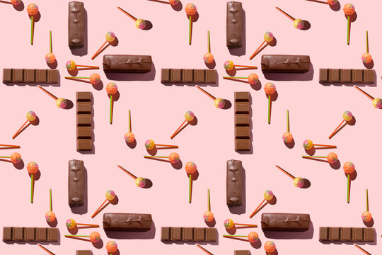Colorful Set of Lollipops and chocolate. pattern made with caramel on a stick and chocolate on bright pink background. creative pattern. - Powered by Adobe