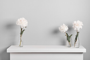 Elegant white peonies flowers arrangement on on fireplace. Minimal Floral decor