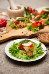 Portion of delicious chicken aspic on serving board on concrete table