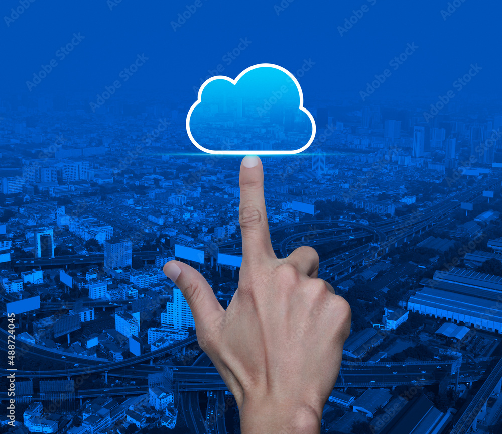 Poster hand click on cloud computing icon with copy space over modern city tower, street, expressway and sk