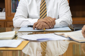 A senior lawyer in formal uniforms is in the middle of a meeting discussing matters in a meeting...