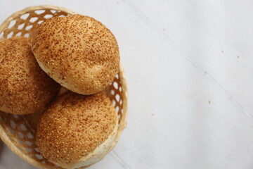 buns with sesame seeds in a basket