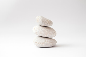 a stack of balancing stones on white background