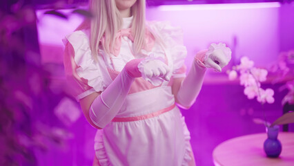 Obraz na płótnie Canvas Headless cute anime cosplay pink maid girl show kitten nyan pose