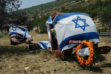 Rusted remains of a convoy of armored vehicles destroyed during Israel's war of independence draped in Israeli flags in observance of Memorial and Independence day holidays. 