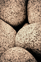 Full frame natural abstract background with round granite stones in sepia style. High resolution image, perfect for interior decoration in Healing by Nature Fine Art Design style.