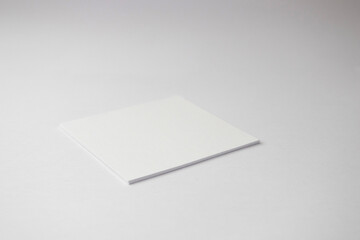 A blank white paper sticker on white background