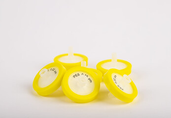 Yellow needle tip filter standing on a white background. They are used in experiments in a...