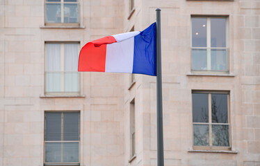 Fototapeta na wymiar Flag of France winding over the buildings from Paris