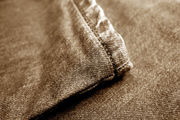 Fototapeta na wymiar Jeans denim texture with blur effect in brown tone.