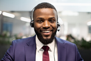 Closeup portrait of african american man in suit using headset