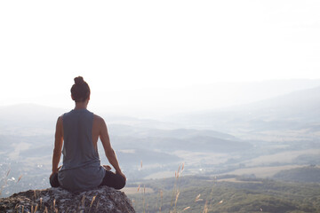 person meditating on the mountain