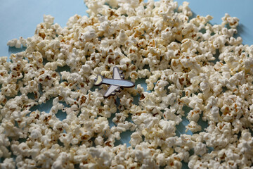 A toy plane over popcorn clouds and blue sky