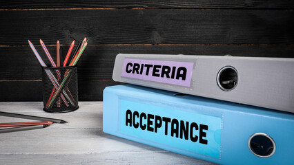 CRITERIA and ACCEPTANCE concept. Two document folders on the office desk