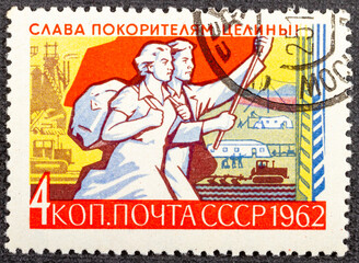 USSR - CIRCA 1962: A stamp printed in Russia shows Farm and Young Couple with Banner, series virgin...