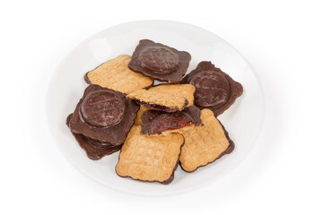 Cookies with chocolate coating and jam filling on white dish