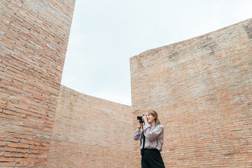 Traveler Asian woman happy smile  taking photo in coliseum architecture at Surin Thailand after recovered from pandemic coronavirus. Travel trip concept after pandemic COVID-19