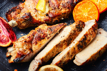 Pork steak roasted with citrus fruits.