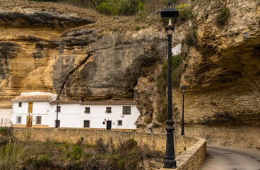 historic whitewashed dewllings under cliff overhangs along the Rio Trejo