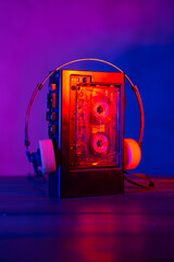 Vintage cassette tape player in neon light. 80s - 90s advertisement style. Disco party nostalgy concept - 488737891
