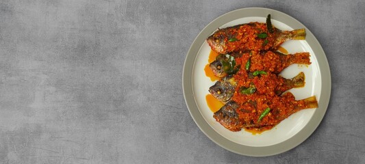 Fried fish cooked with spicy seasoning or spicy sasuce