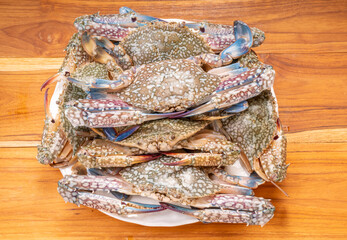 Fresh seafood  blue crab on wooden background  ready to cook.