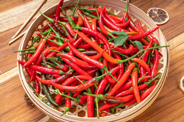 Red hot chili peppers on bamboo basket, Red chilli for hot and spicy Thai cooking food.
