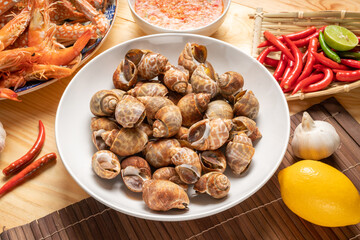 Seafood dish, steamed  areola babylon or spotted babylon , served with Thai spicy and sour seafood...