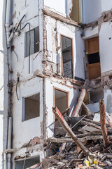building in ruin with a collapsed wall and visible damaged apartments